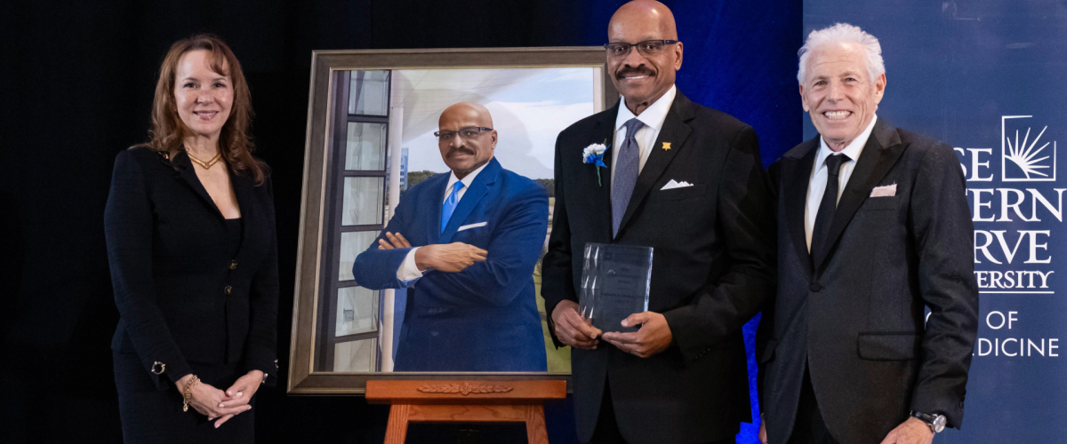 Dean Chance and Nance standing around his portrait 