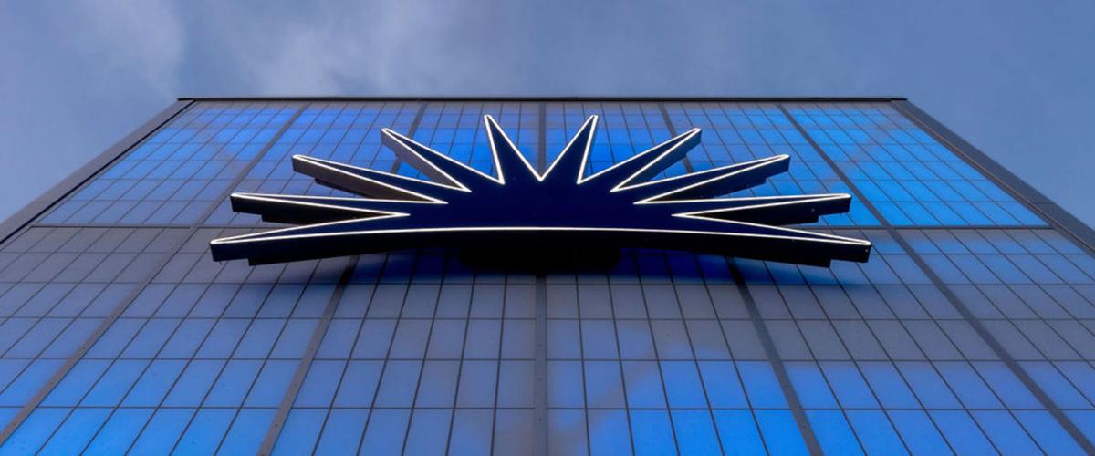 Photo of the light-up CWRU logo on the back of a campus building