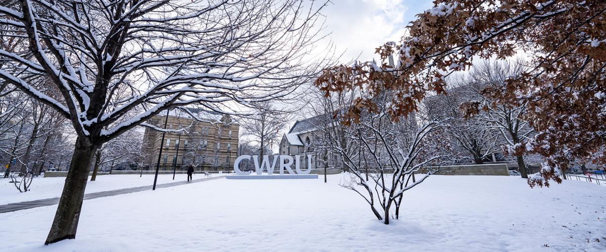 Photo of the CWRU letters on campus surrounded by snow