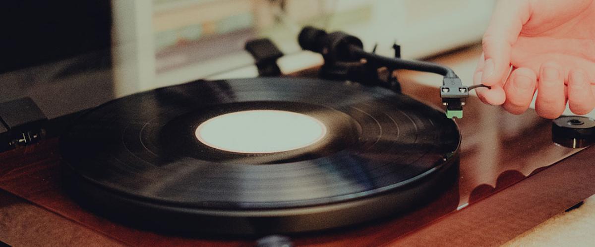 Close up photo of a person playing a record