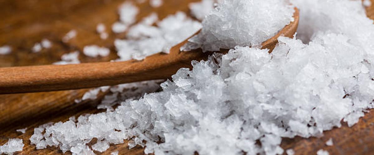 sea salt on table with wooden spoon