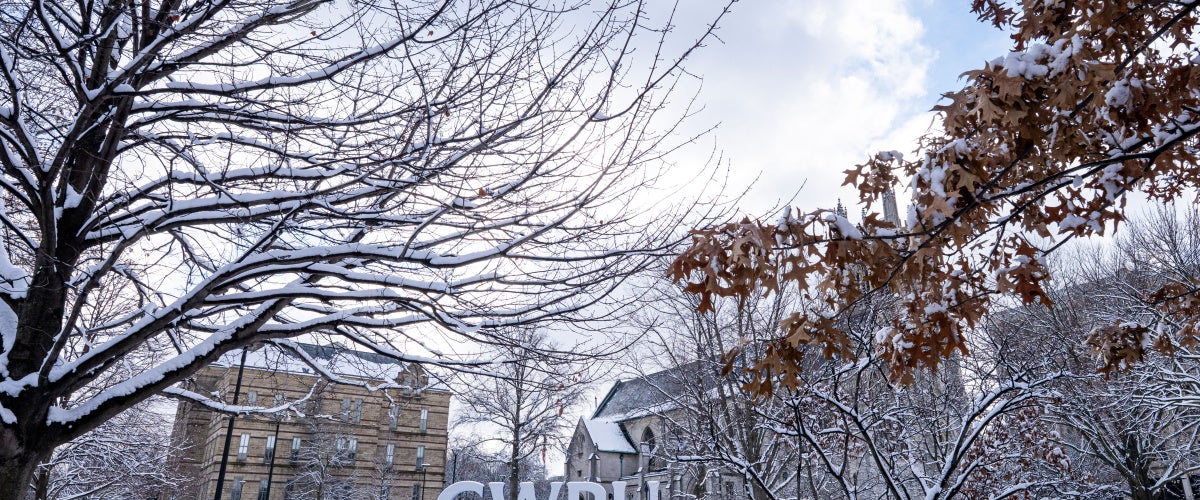 C-W-R-U letters sign covered in snow alongside the Binary Walkway.