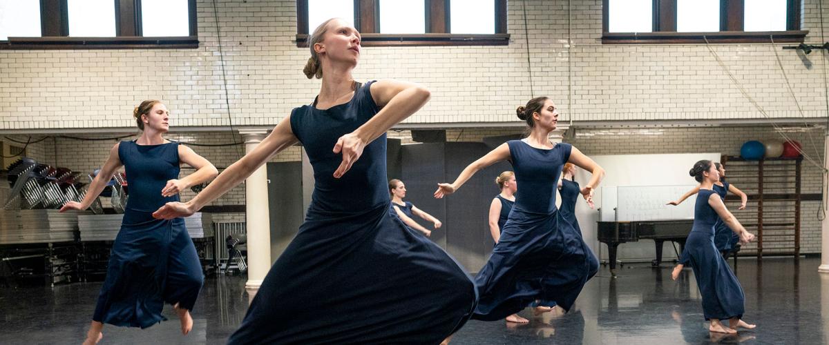 Photo of CWRU dancers mid-leap rehearsing for Martha Graham dance