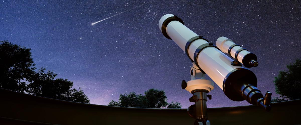 Telescope points to starry night sky