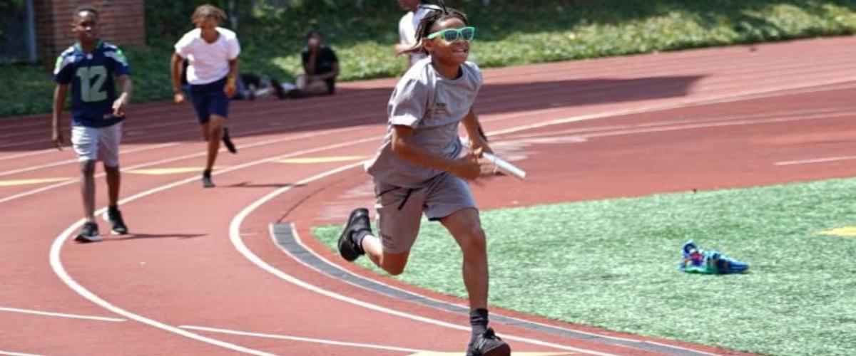 NYSP participants run on a track field