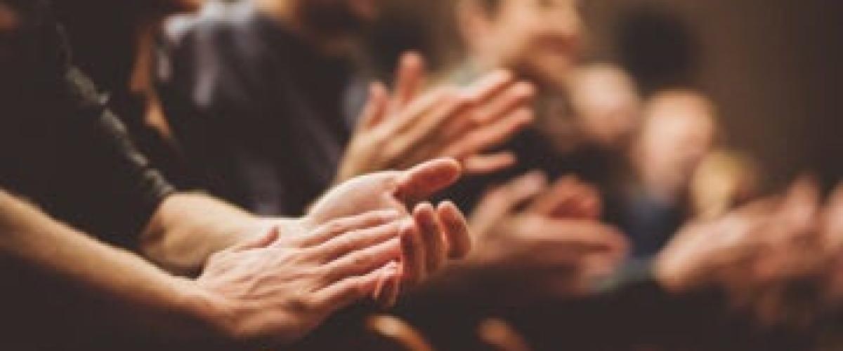 Several people clapping their hands