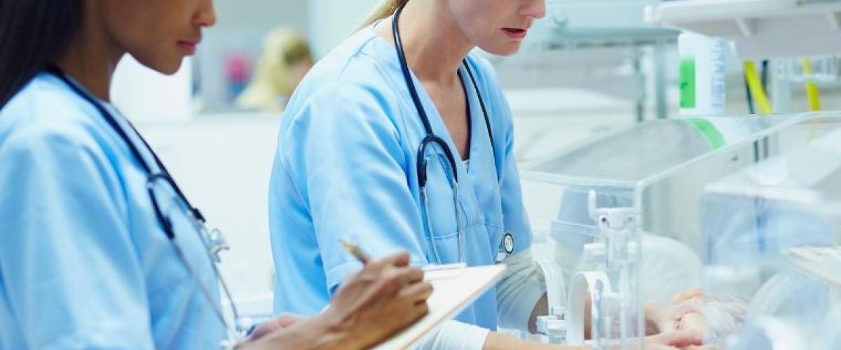 Nurses-monitoring-baby-in-incubator