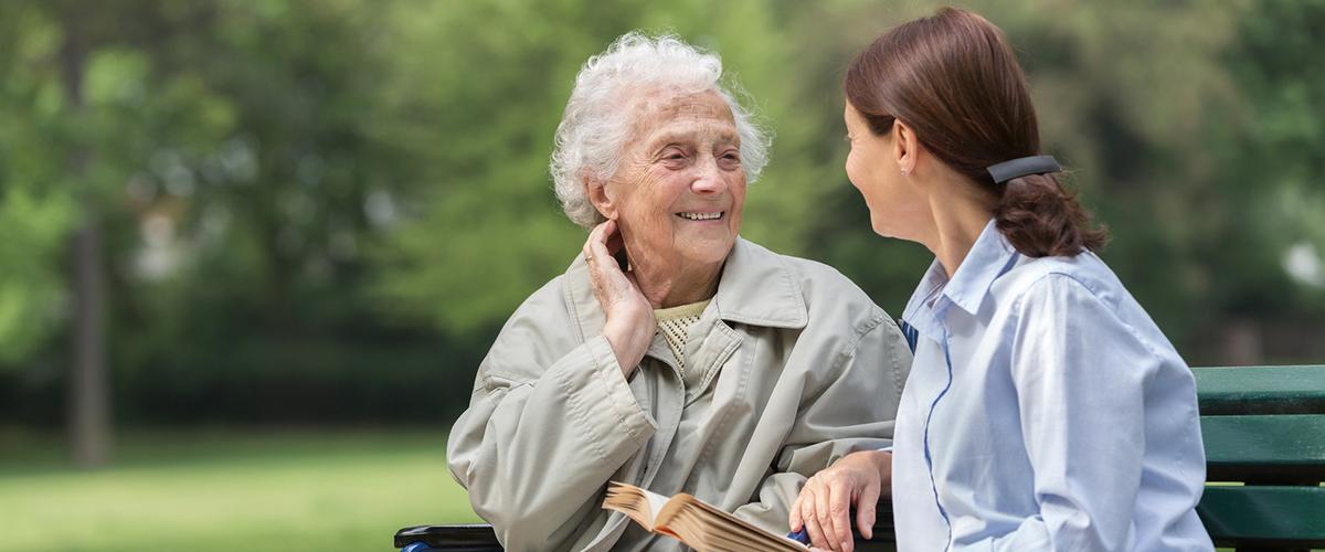 Two women talking on a bench