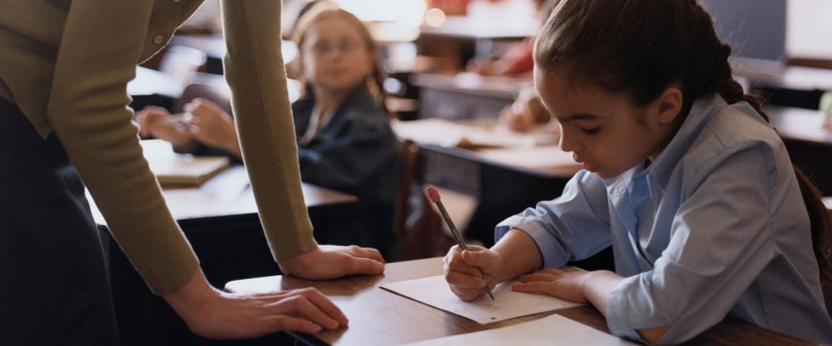 woman-helping-girl-at-school