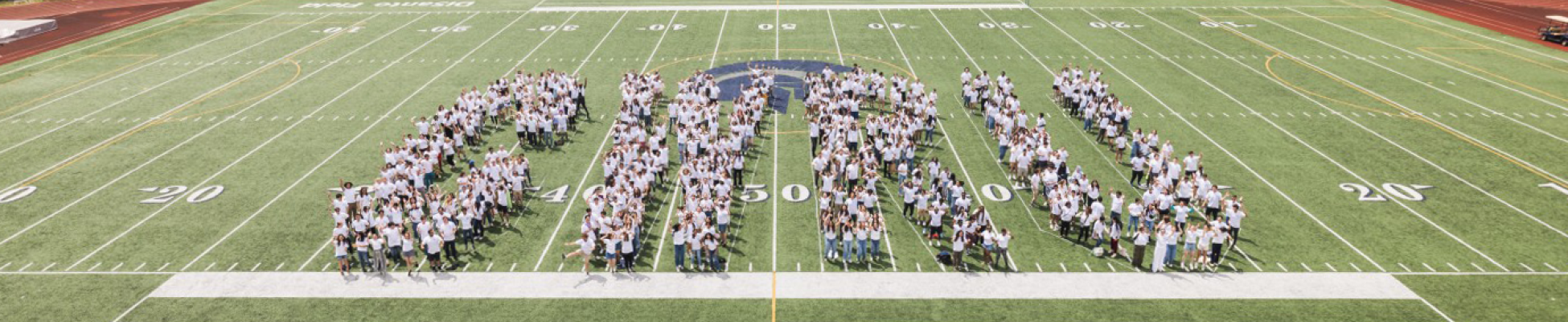 The graduating class of 2024 spelling 'CWRU' on the football field