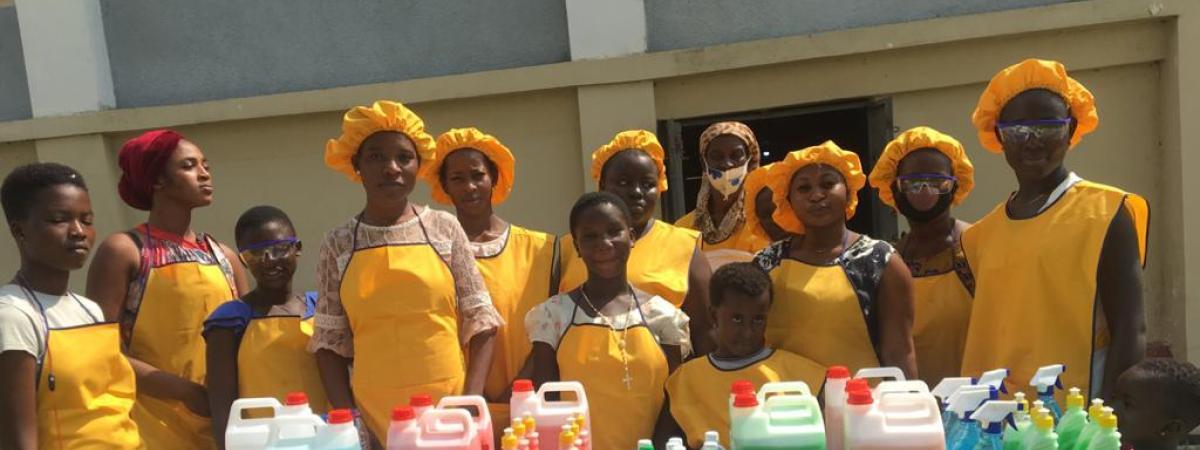 An image of a group of girls standing behind a table.