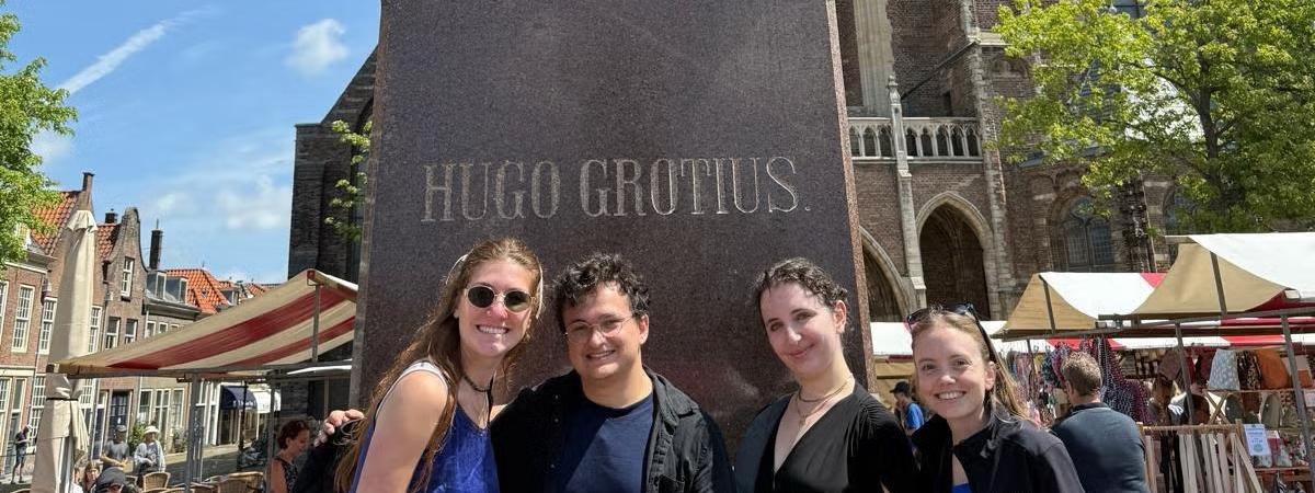 Standing in front of the famed Statute of Hugo Grotius, the Father of International Law, in The Netherlands, from Left to right: Kaylara Benfield, Oliber Bates, Teresa Lebowitz and Maria Blough