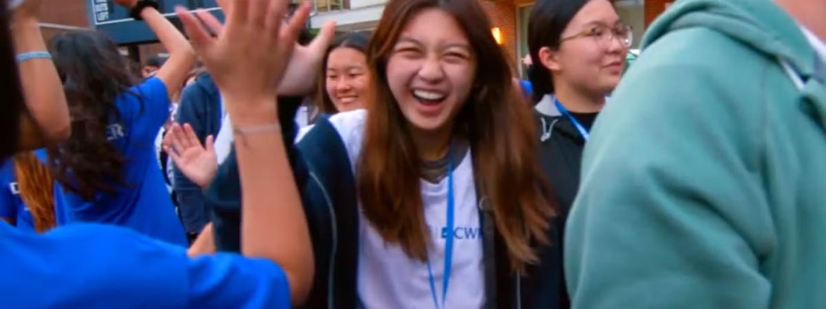 Student laughing in a crowd