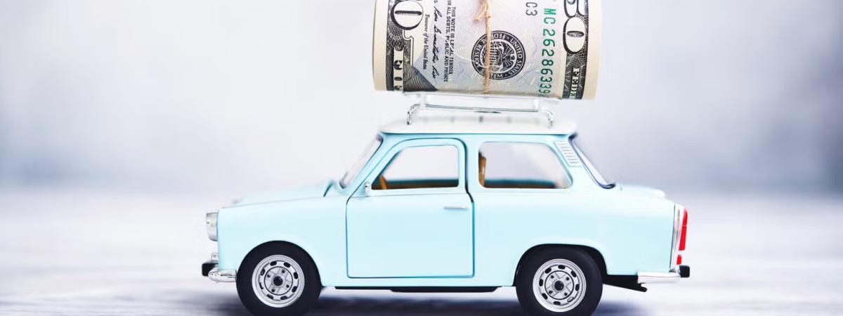 Small blue car with money on top