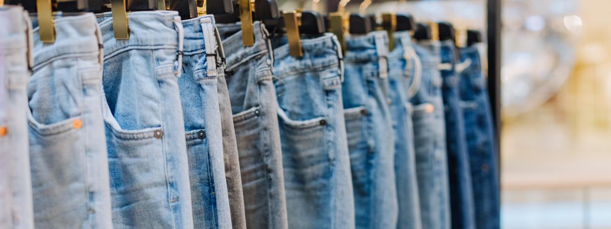 Denim jeans on a rack in a storefront