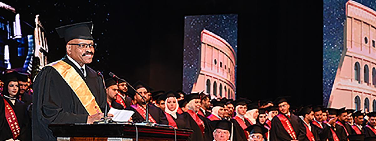 Dean Chance stands at a podium to give the commencement address at Future University in Cairo