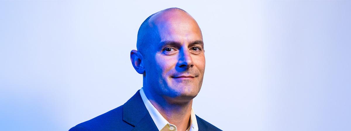 A photographic portrait of Jeff Capadona in blue suit
