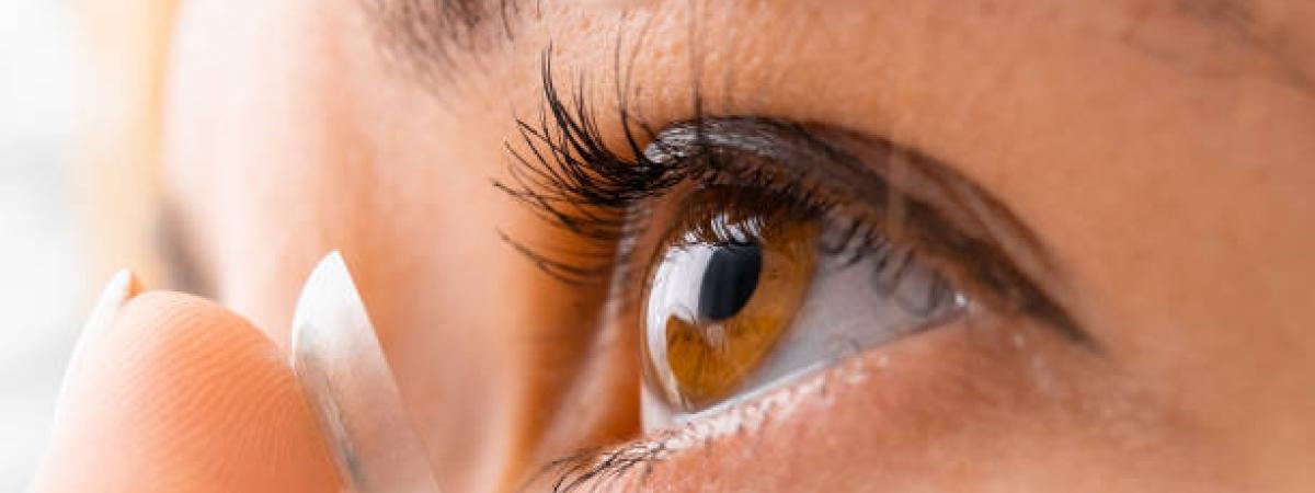 woman putting in contact lenses