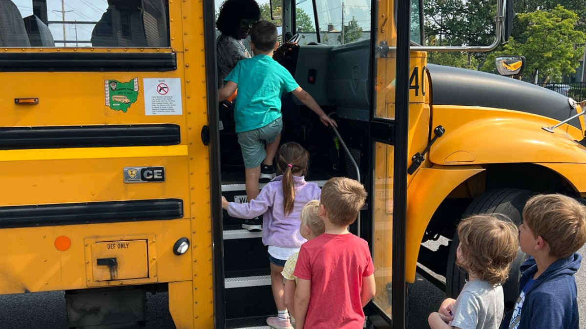 Photo of young children boarding a school bus