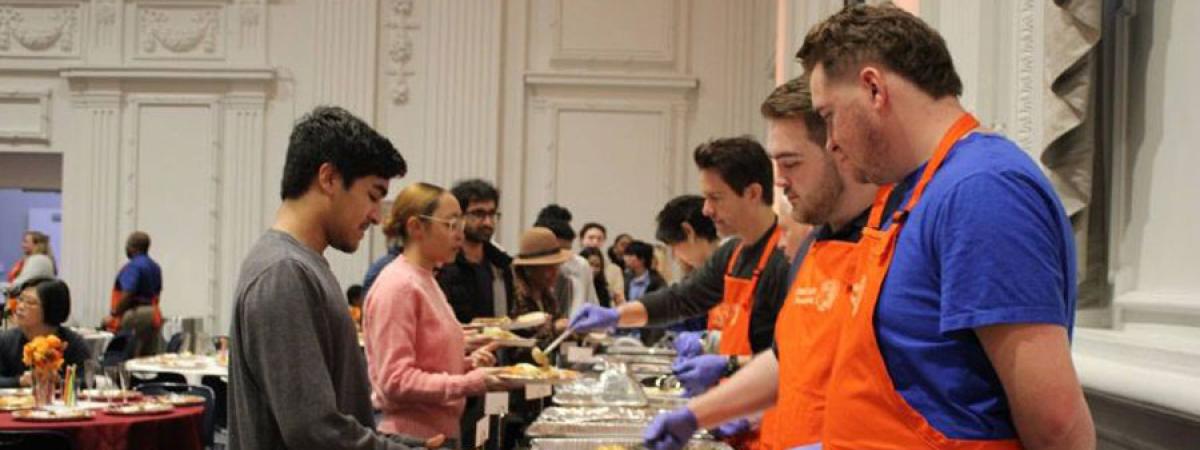 Photo of volunteers serving food to students and their families at CWRU Family Thanksgiving in 2024