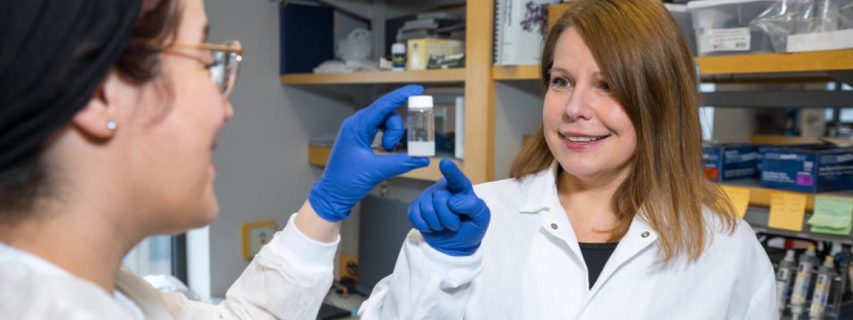 Agata Exner looking at materials in a lab with a student