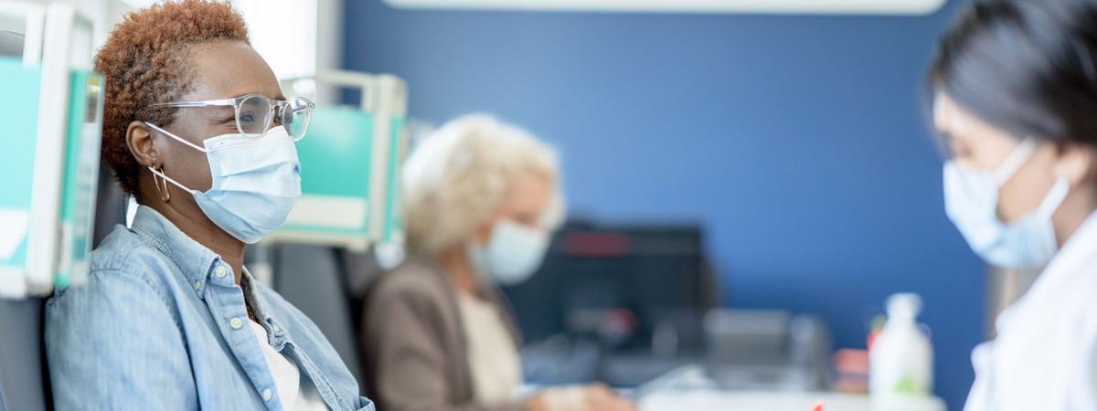 Photo of a patient with a healthcare professional during a cancer clinical trial