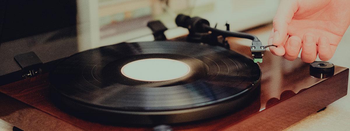 Close up photo of a person playing a record