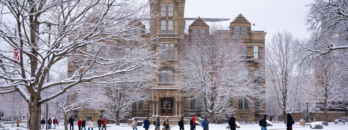 Students walk in front of Case Western Reserve University's Adelbert Hall on a snowy day
