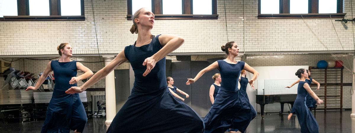 Photo of CWRU dancers mid-leap rehearsing for Martha Graham dance