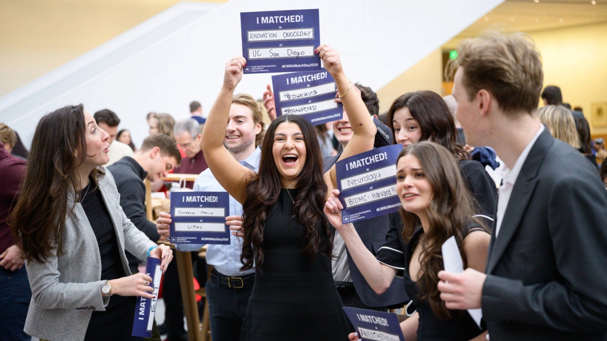 students holding up signs that read "I matched!"