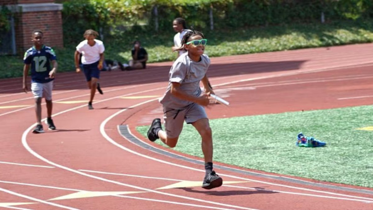 NYSP participants run on a track field