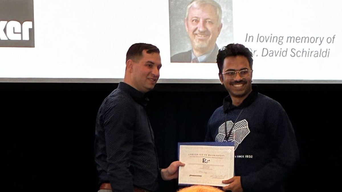 Photo of Rishab Kundu accepts award at conference