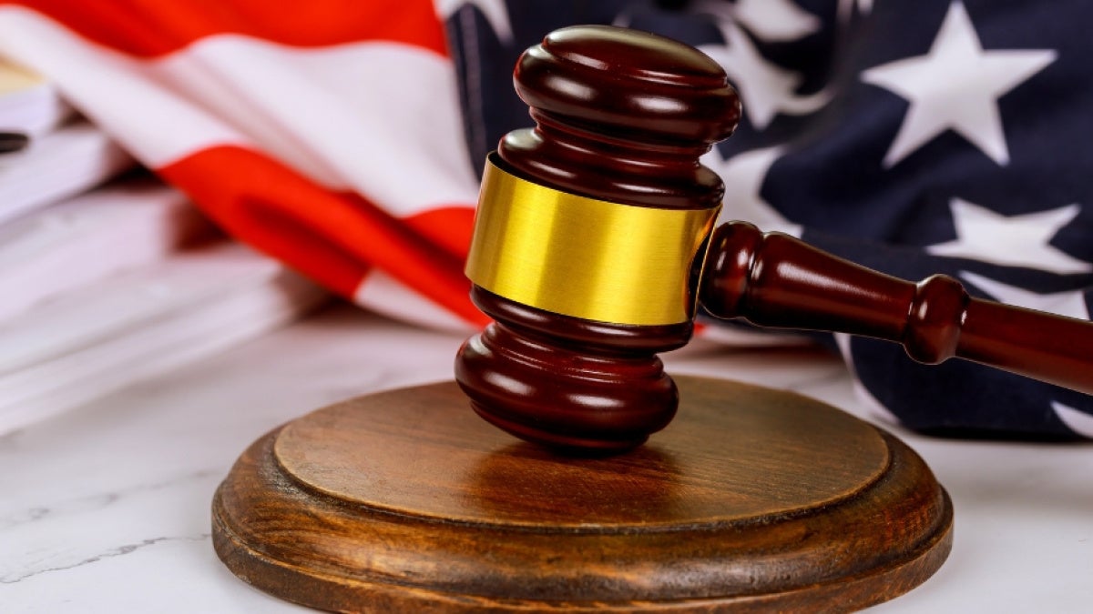 A gavel with a background of the American flag
