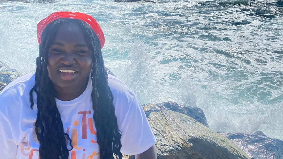 Ruth Boampong poses for a photo in front of a body of water