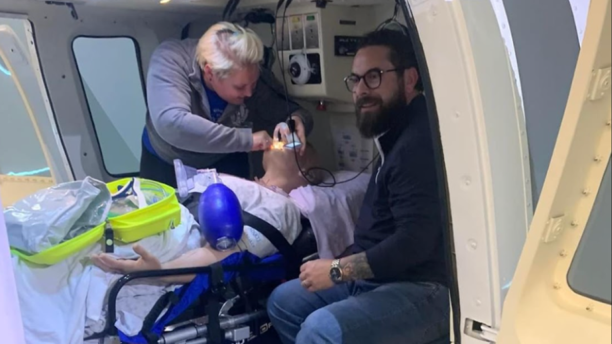 Raquel Dauch and coworker work on a simulation patient on a helicopter.