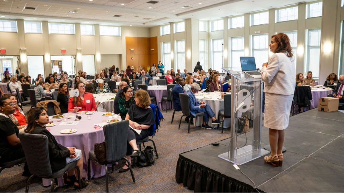 faculty attendees at round tables listening to a speaker at the WFSOM dinner