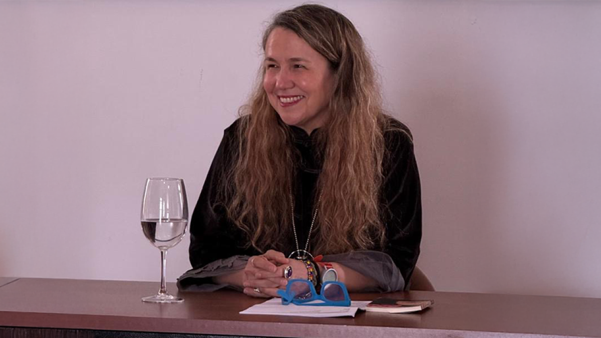 Damaris Puñales-Alpizar sitting at a table