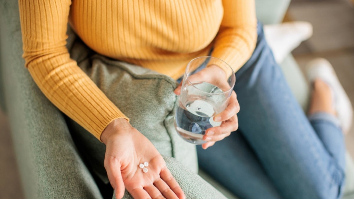 Close up of an unidentified person taking medication 
