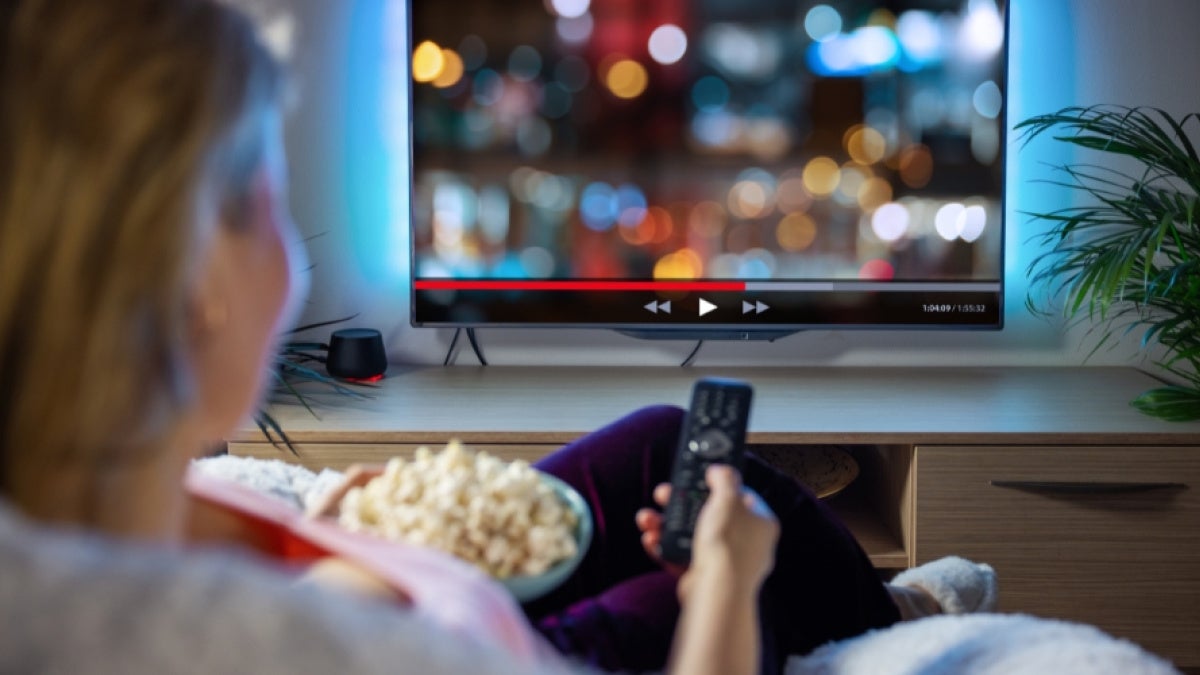 View of unidentified woman watching TV