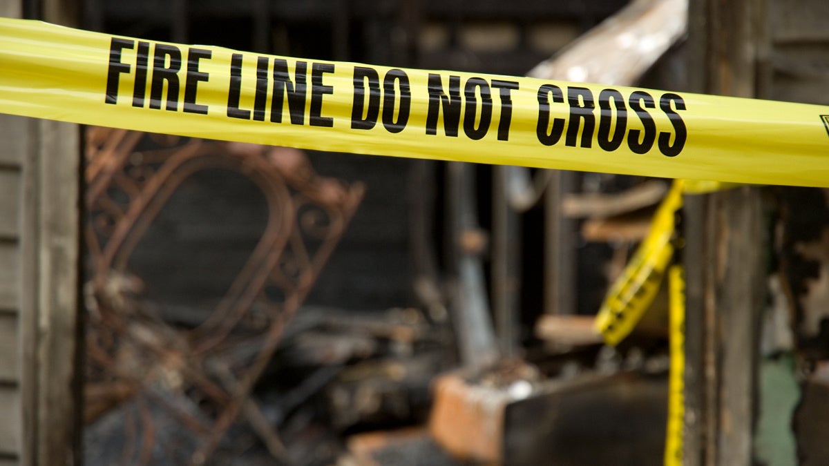 Image of yellow tapes at a fire scene