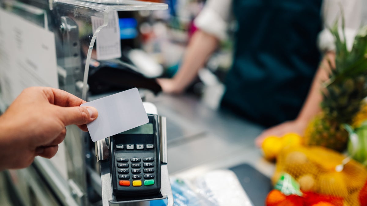 Image of a credit card being tapped on card payment machine