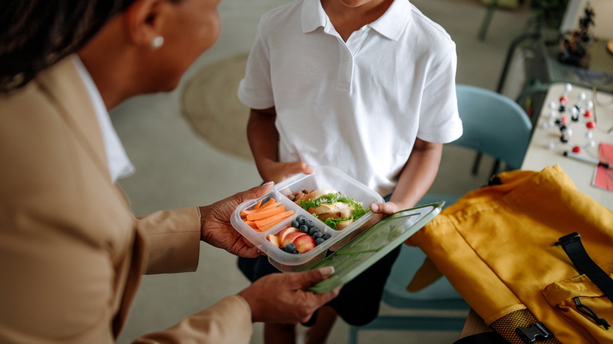 Image of a mother packing lunch for her son
