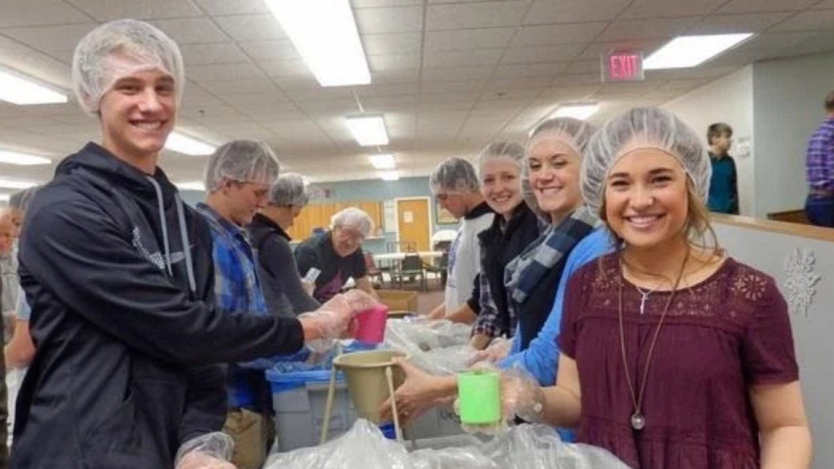 Members of Kids Against Hunger participate in a community service activity. 