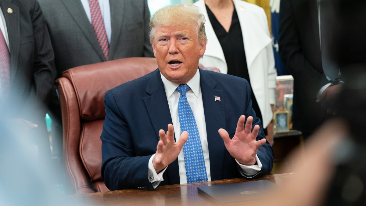 Image of Trump speaking to the media after signing the housing executive orders