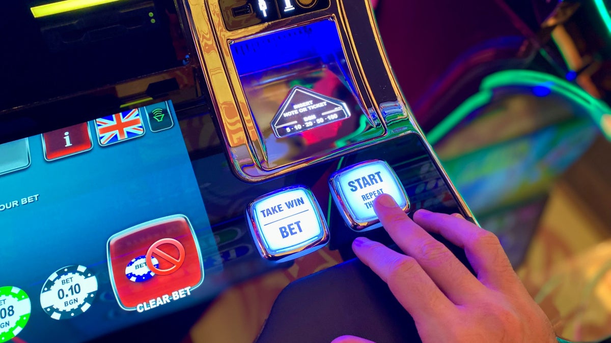 Image of a hand placing a bet on a virtual game machine