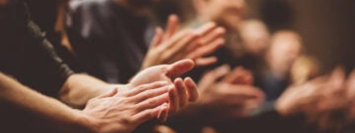 Several people clapping their hands