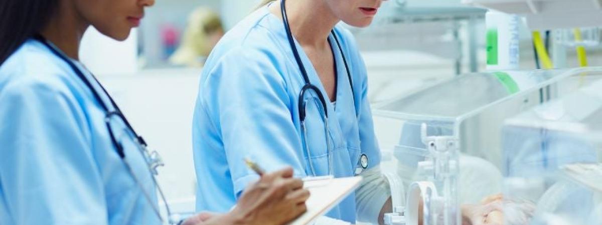 Nurses-monitoring-baby-in-incubator