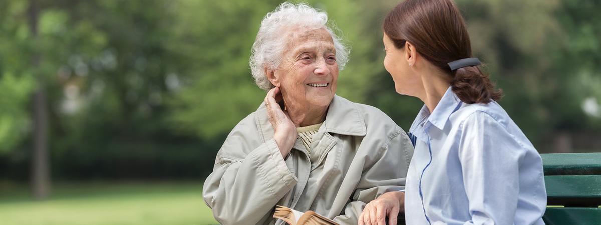 Two women talking on a bench