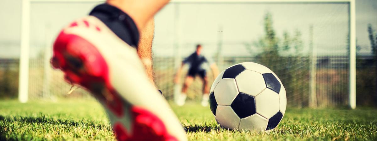 soccer-player-kicking-ball