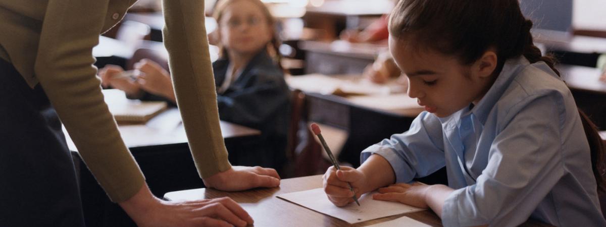 woman-helping-girl-at-school